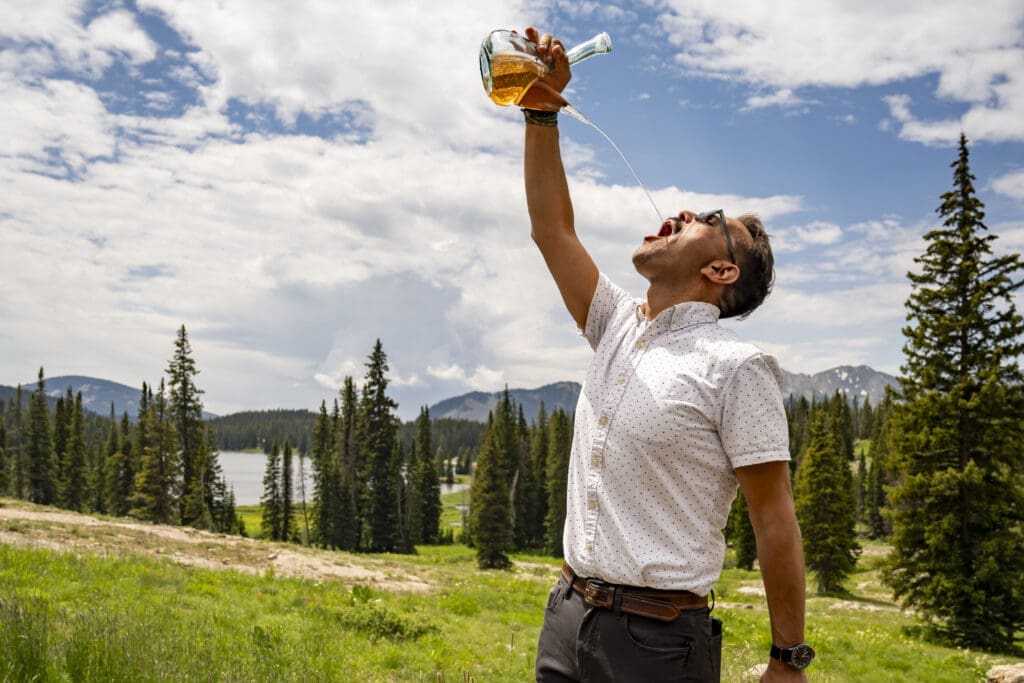 A man pouring wine into his mouth