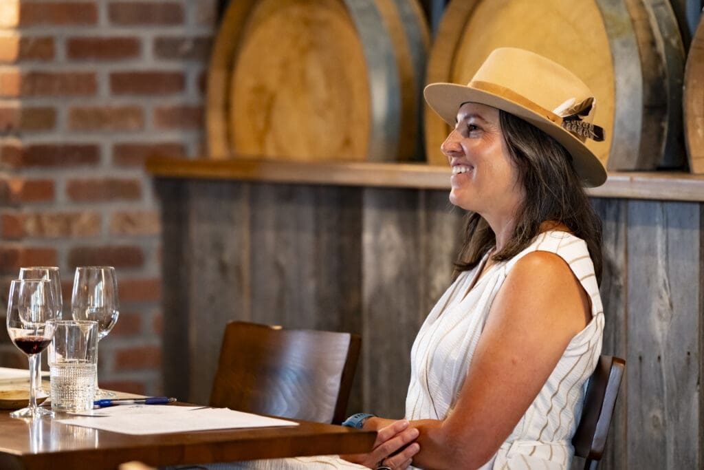 A women sitting at a table smiling