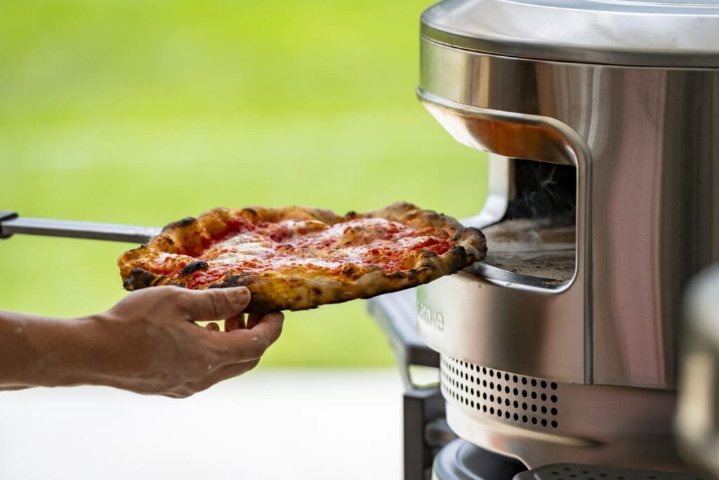 Pizza going into an oven