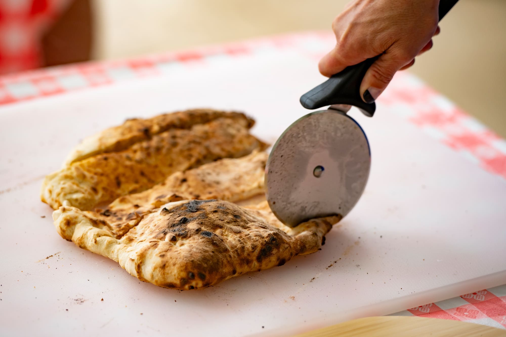 Pizza crust being cut